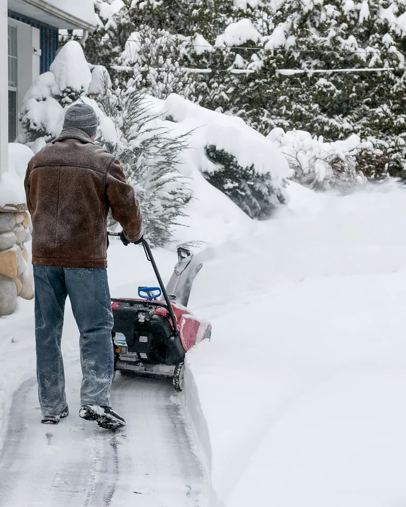 bigstock-Man-using-snowblower-to-clear--77541071
